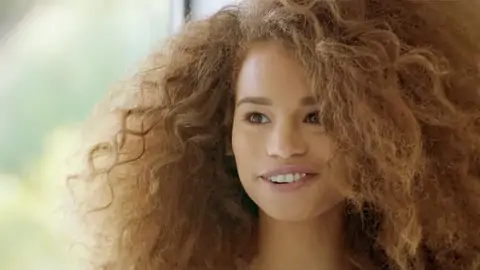 Teenager Dark-hued With Wavy Hair Is Riding A Huge Salami On The Couch